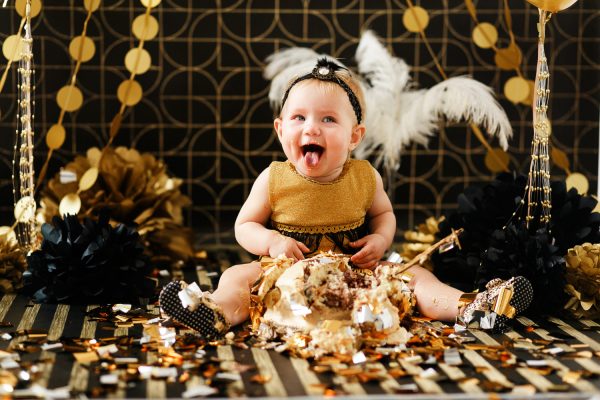 happy-baby-eating-cake-her-first-birthday-party-cakesmash-little-girl